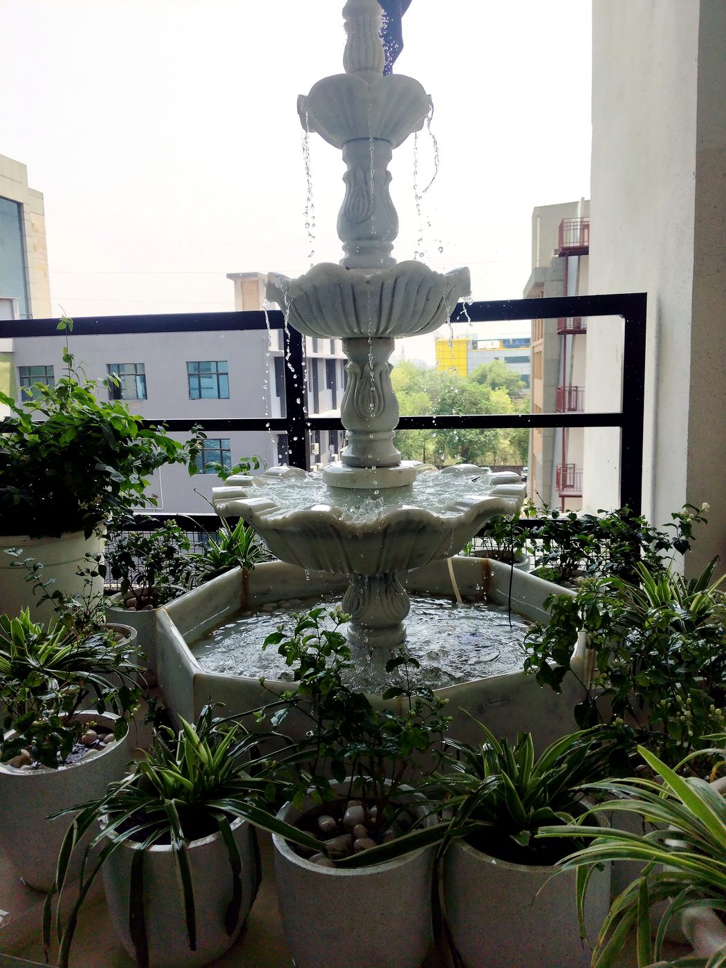 Balcony water fountain with potted plants