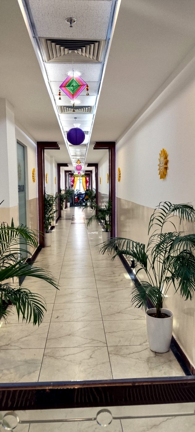 Indoor corridor lined with palms